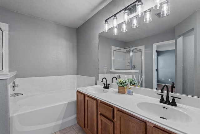1503 Sherry Dr, Taylor, TX 76574 - bathroom featuring a bath, a stall shower, tile patterned floors, and double vanity
