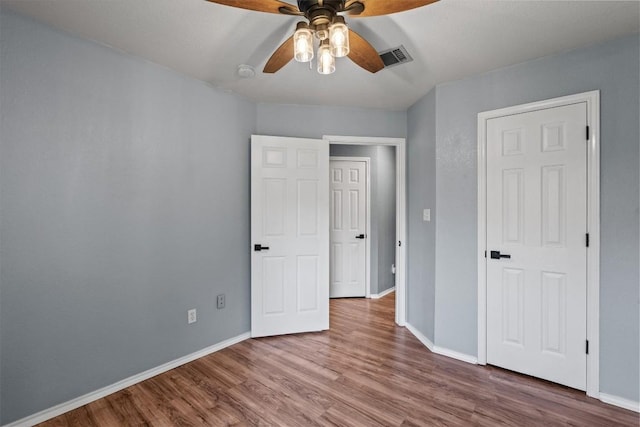 1503 Sherry Dr, Taylor, TX 76574 - unfurnished bedroom with wood finished floors and ceiling fan