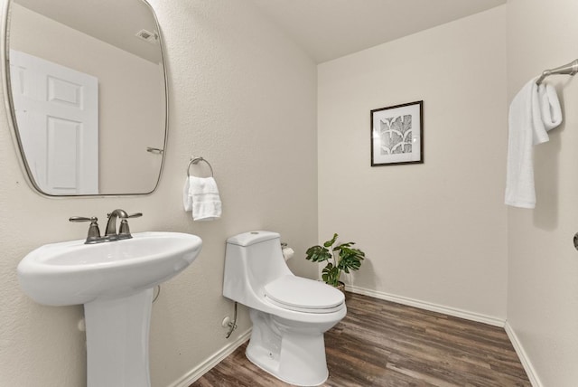 1305 Cozy Creek Dr, Temple, TX 76502 - half bathroom featuring wood finished floors and toilet