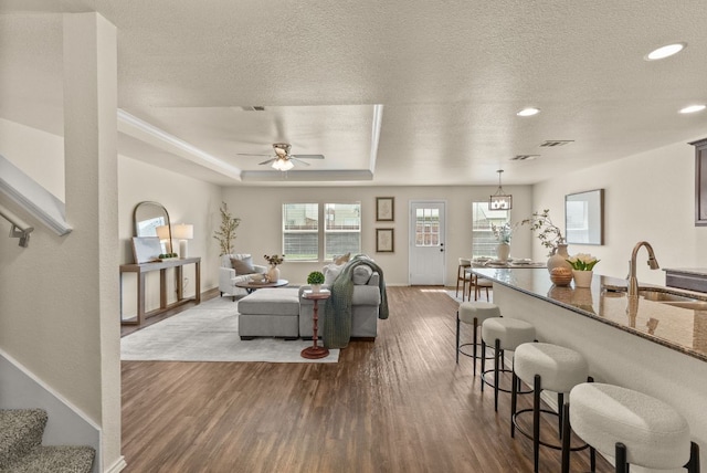 1305 Cozy Creek Dr, Temple, TX 76502 - living area featuring dark wood-style floors, ceiling fan, a textured ceiling, recessed lighting, and stairs