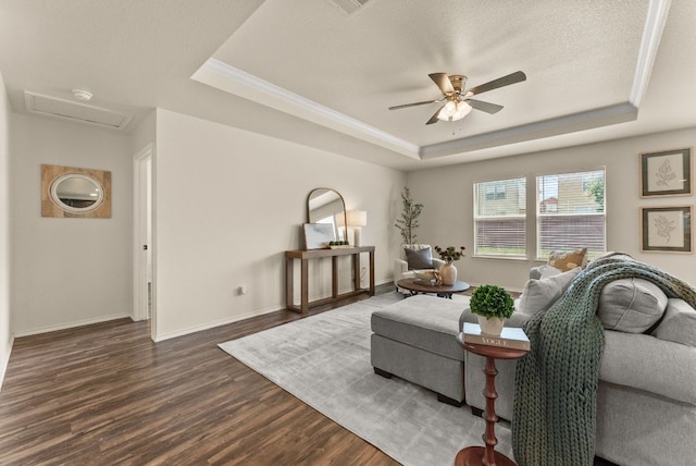 1305 Cozy Creek Dr, Temple, TX 76502 - living area with a tray ceiling, dark wood finished floors, ceiling fan, attic access, and crown molding