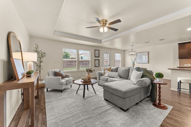1305 Cozy Creek Dr, Temple, TX 76502 - living room with a raised ceiling, light wood-style flooring, and a ceiling fan