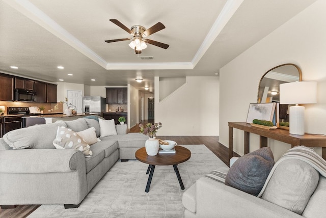 1305 Cozy Creek Dr, Temple, TX 76502 - living area featuring a raised ceiling, light wood finished floors, recessed lighting, ornamental molding, and a ceiling fan