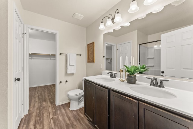 1305 Cozy Creek Dr, Temple, TX 76502 - full bath with a shower with door, wood finished floors, double vanity, and a walk in closet