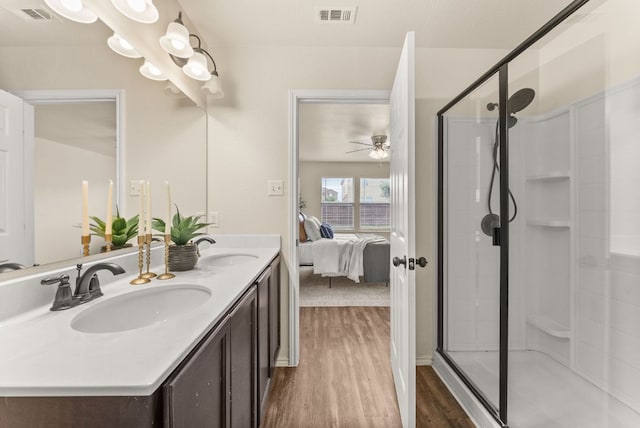 1305 Cozy Creek Dr, Temple, TX 76502 - full bathroom featuring wood finished floors, ensuite bath, a ceiling fan, double vanity, and a stall shower