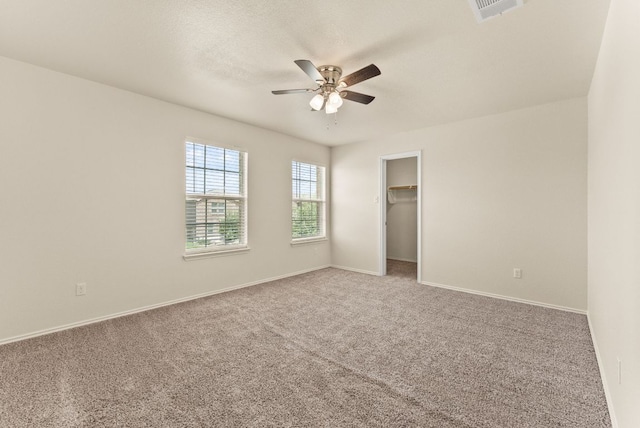 1305 Cozy Creek Dr, Temple, TX 76502 - unfurnished bedroom featuring carpet floors, a walk in closet, and a ceiling fan