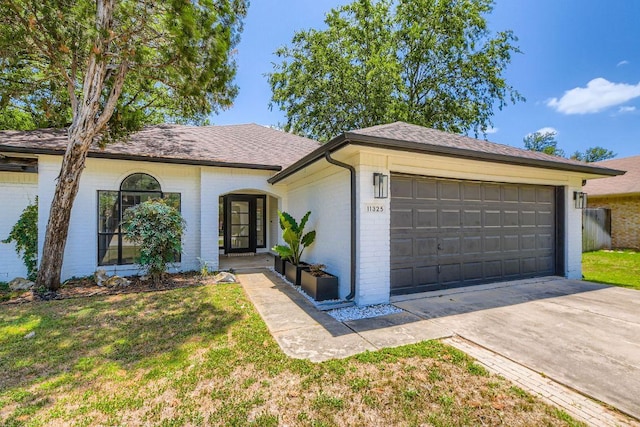 11325 Stormy Ridge Rd, Austin, TX 78739 - single story home with brick siding, a front yard, an attached garage, and roof with shingles