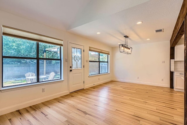 11325 Stormy Ridge Rd, Austin, TX 78739 - foyer with a chandelier, light wood-style floors, and recessed lighting