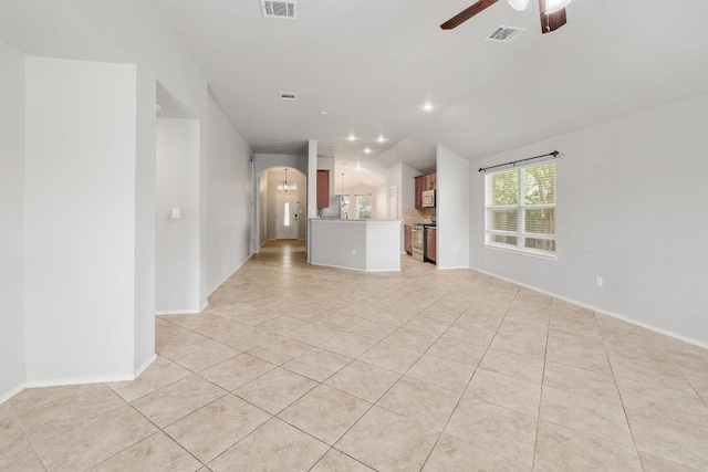 17729 Cahir Glen Cv, Pflugerville, TX 78660 - unfurnished living room featuring light tile patterned floors, a ceiling fan, arched walkways, and vaulted ceiling