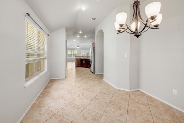 17729 Cahir Glen Cv, Pflugerville, TX 78660 - empty room with a chandelier, arched walkways, light tile patterned flooring, and ceiling fan
