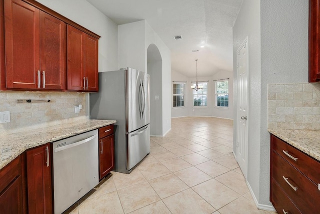 17729 Cahir Glen Cv, Pflugerville, TX 78660 - kitchen featuring appliances with stainless steel finishes, backsplash, vaulted ceiling, light tile patterned floors, and a chandelier