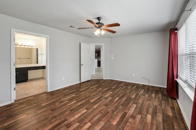 17729 Cahir Glen Cv, Pflugerville, TX 78660 - unfurnished bedroom with wood finished floors, a ceiling fan, and ensuite bath
