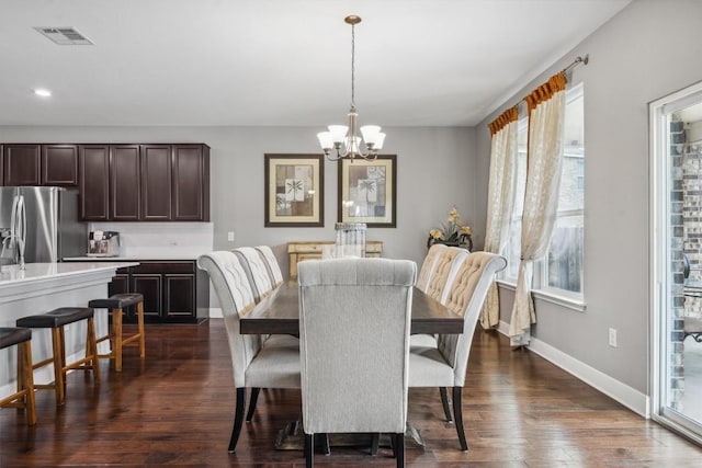 7016 Lickeen Ct, Austin, TX 78744 - dining area with a chandelier, plenty of natural light, dark wood-style flooring, and recessed lighting