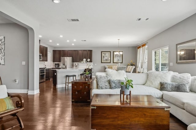 7016 Lickeen Ct, Austin, TX 78744 - living area with recessed lighting, dark wood finished floors, and a chandelier