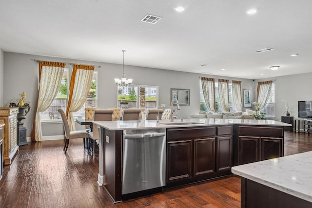7016 Lickeen Ct, Austin, TX 78744 - kitchen with dishwasher, open floor plan, dark brown cabinets, recessed lighting, and a chandelier