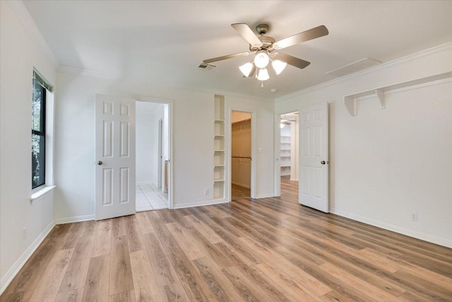 1303UNIT13A N Cuernavaca Dr Unit A13, Austin, TX 78733 - unfurnished bedroom with light wood finished floors, ornamental molding, a spacious closet, and a ceiling fan