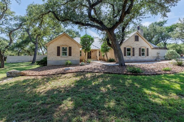 110 Lost River Rd, Georgetown, TX 78628 - ranch-style home with a chimney, stone siding, and a front lawn