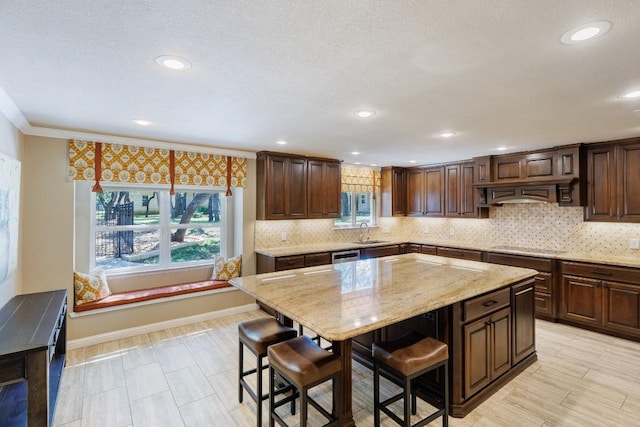 110 Lost River Rd, Georgetown, TX 78628 - kitchen featuring a breakfast bar, light stone countertops, a center island, backsplash, and recessed lighting