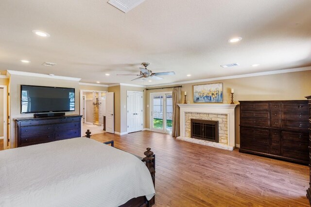 110 Lost River Rd, Georgetown, TX 78628 - bedroom featuring crown molding, recessed lighting, access to exterior, wood finished floors, and a fireplace