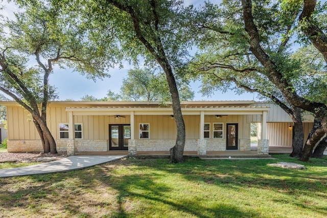 110 Lost River Rd, Georgetown, TX 78628 - view of front of home featuring ceiling fan, board and batten siding, french doors, and a front lawn