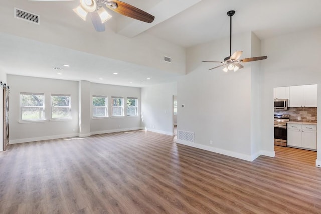 110 Lost River Rd, Georgetown, TX 78628 - unfurnished living room featuring ceiling fan, light wood-type flooring, recessed lighting, and beamed ceiling