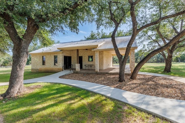 110 Lost River Rd, Georgetown, TX 78628 - single story home with a ceiling fan, a front lawn, stone siding, and a metal roof