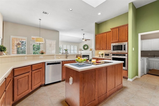 10628 Indigo Broom Loop, Austin, TX 78733 - kitchen featuring appliances with stainless steel finishes, backsplash, light tile patterned floors, ceiling fan, and recessed lighting