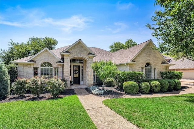 10628 Indigo Broom Loop, Austin, TX 78733 - french country home with stone siding and a front lawn