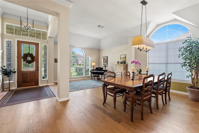 10628 Indigo Broom Loop, Austin, TX 78733 - dining area featuring a chandelier, hardwood / wood-style floors, lofted ceiling, and ornamental molding