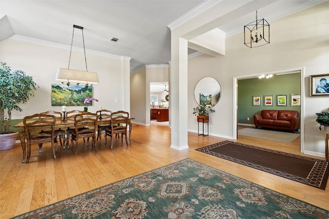 10628 Indigo Broom Loop, Austin, TX 78733 - dining space featuring wood-type flooring, ornamental molding, and a chandelier