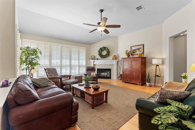 10628 Indigo Broom Loop, Austin, TX 78733 - living area featuring ceiling fan, light wood-style flooring, and a tile fireplace