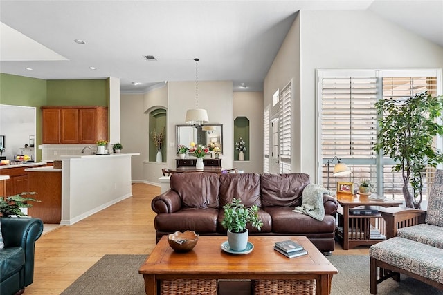 10628 Indigo Broom Loop, Austin, TX 78733 - living area with light wood finished floors, arched walkways, and recessed lighting