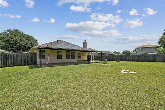 103 Towan Way, Hutto, TX 78634 - rear view of property with a patio area, a fenced backyard, and roof mounted solar panels
