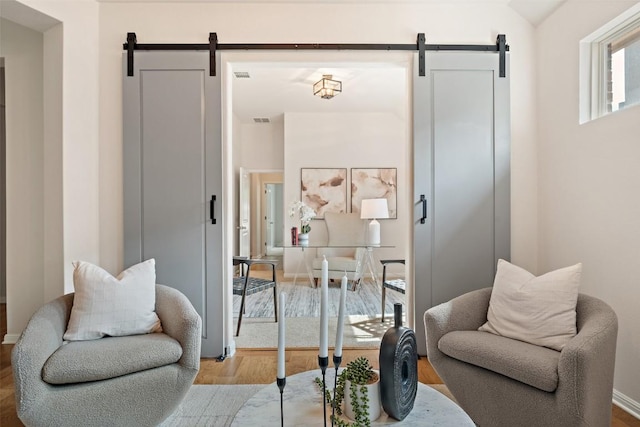 18517 Tanner Bayou Loop, Austin, TX 78738 - living area with a barn door and wood finished floors