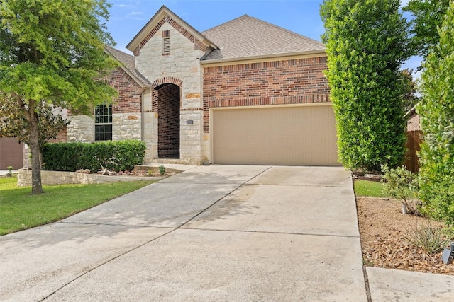 18517 Tanner Bayou Loop, Austin, TX 78738 - french provincial home with stone siding, driveway, a shingled roof, and a garage