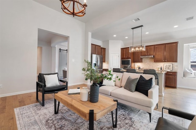 18517 Tanner Bayou Loop, Austin, TX 78738 - living area with a chandelier, light wood-style flooring, and recessed lighting
