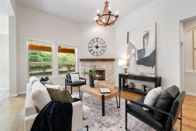 18517 Tanner Bayou Loop, Austin, TX 78738 - living area with a fireplace, a chandelier, wood finished floors, and a towering ceiling
