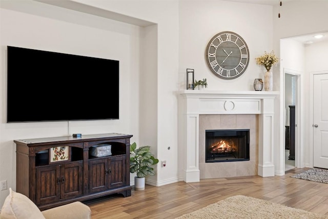 22300 Chipotle Pass, Spicewood, TX 78669 - living area featuring a tiled fireplace and light wood-style flooring