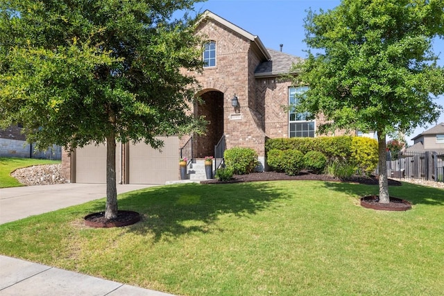 22300 Chipotle Pass, Spicewood, TX 78669 - view of front facade featuring driveway, brick siding, and a garage