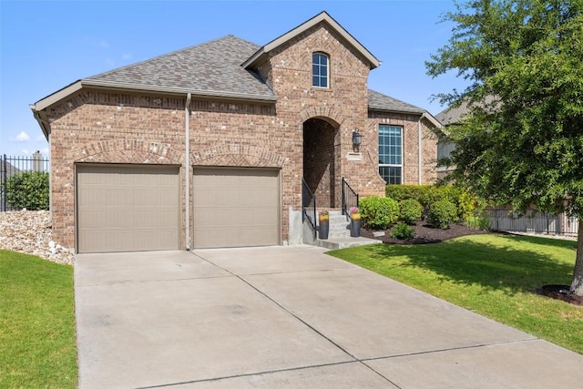 22300 Chipotle Pass, Spicewood, TX 78669 - view of front of house with brick siding, concrete driveway, roof with shingles, and an attached garage