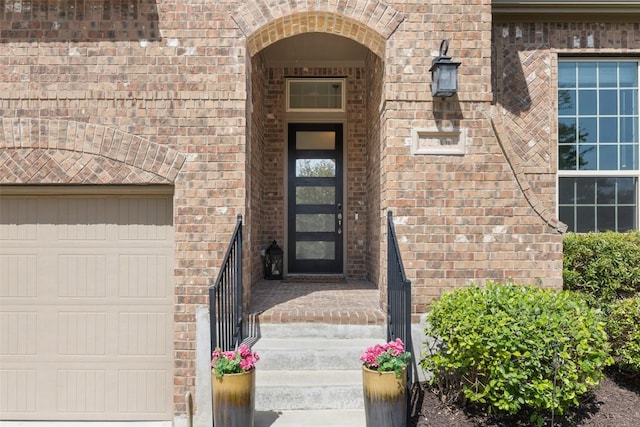 22300 Chipotle Pass, Spicewood, TX 78669 - doorway to property featuring brick siding and a garage