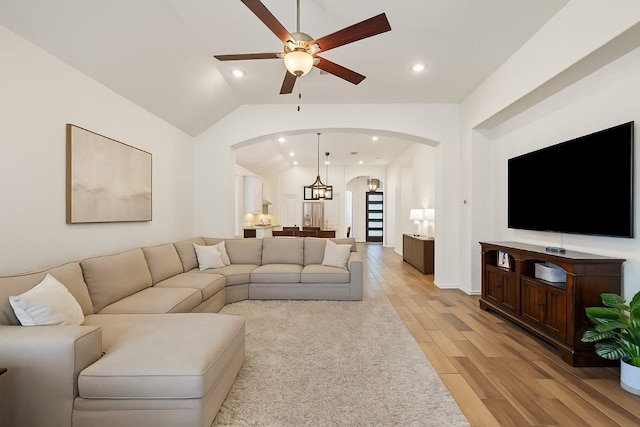 22300 Chipotle Pass, Spicewood, TX 78669 - living room with lofted ceiling, arched walkways, ceiling fan, light wood-type flooring, and recessed lighting