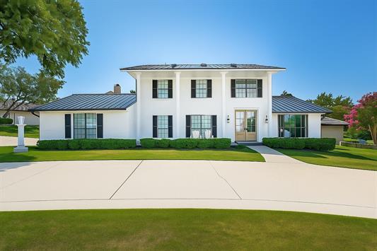 608 Sombrero Dr, Horseshoe Bay, TX 78657 - greek revival inspired property featuring a standing seam roof, a metal roof, a front yard, and stucco siding