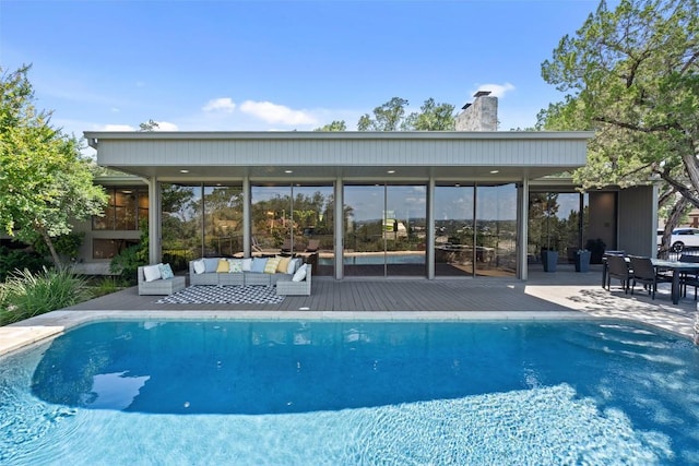 821 Malabar St, Austin, TX 78734 - rear view of house featuring an outdoor living space, a chimney, a deck, and an outdoor pool