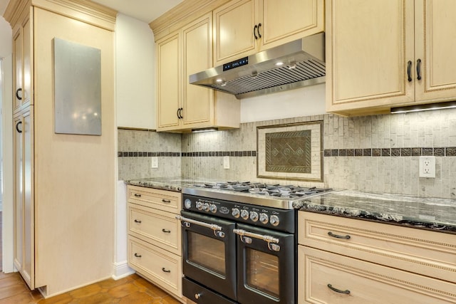 10701 Glass Mountain Trl, Austin, TX 78750 - kitchen featuring double oven range, under cabinet range hood, cream cabinetry, and tasteful backsplash