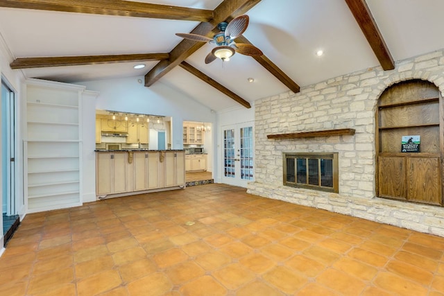 10701 Glass Mountain Trl, Austin, TX 78750 - unfurnished living room with ceiling fan, a stone fireplace, french doors, and tile patterned flooring