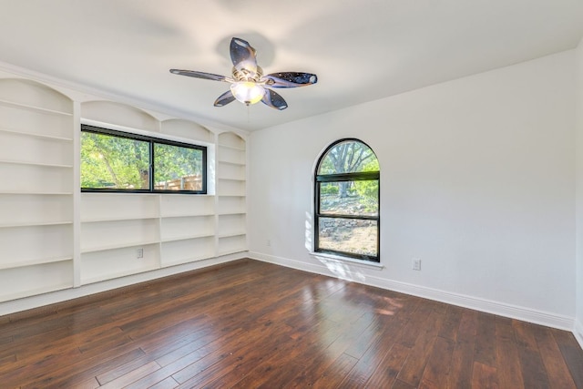 10701 Glass Mountain Trl, Austin, TX 78750 - unfurnished room featuring built in shelves, ceiling fan, and dark wood finished floors