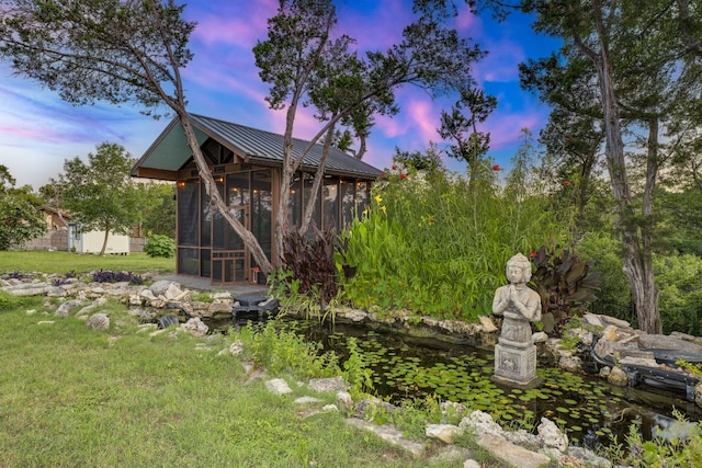 10701 Glass Mountain Trl, Austin, TX 78750 - view of yard with a sunroom and a small pond