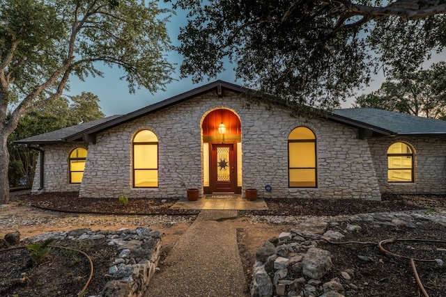 10701 Glass Mountain Trl, Austin, TX 78750 - view of front of home with stone siding and a shingled roof