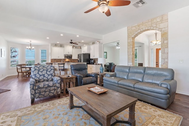 30112 Twin Creek Dr, Georgetown, TX 78626 - living room featuring ceiling fan, wood finished floors, arched walkways, a chandelier, and recessed lighting